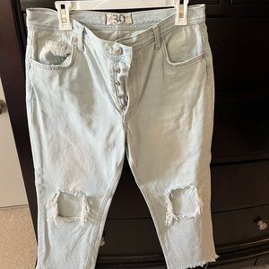 Free People distressed ankle jeans.